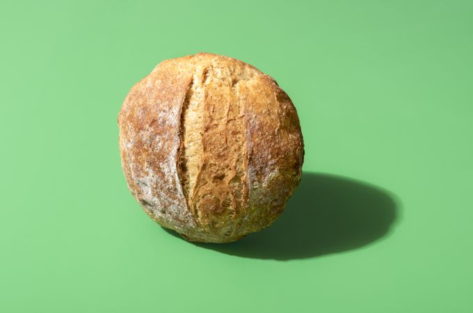 Homemade bread on a vibrant green background