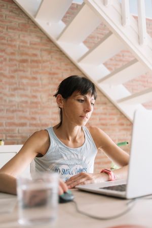 Woman working at laptop in bright loft