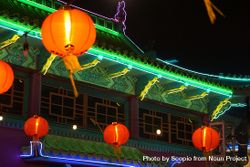 Red lit lanterns near pagoda at night 0VJxD0