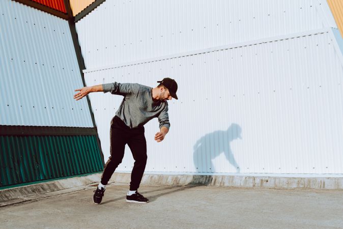 Trendy male flipping on street