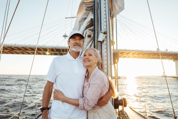 Loving older couple enjoying the view on a sailboat