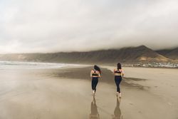 Anonymous women running near sea