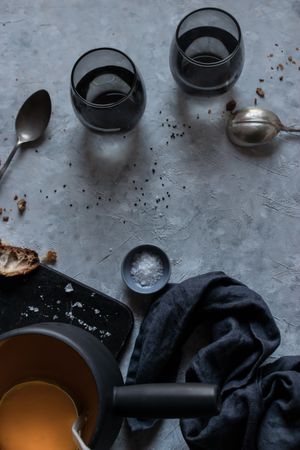 Glasses and spoons near pumpkin cream soup