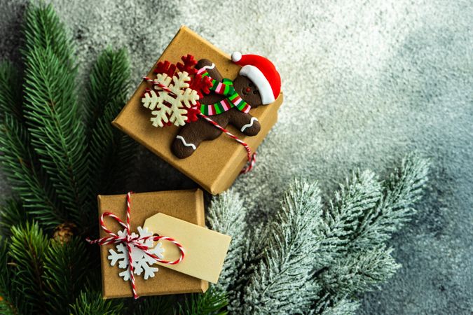 Christmas gifts with pine and gingerbread ornament copy space