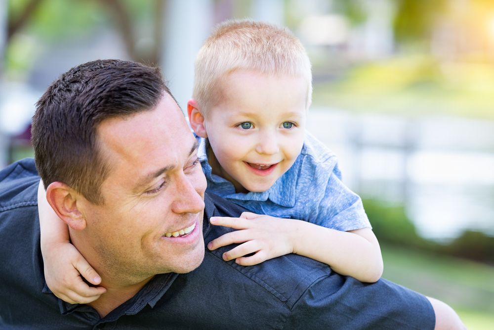 White Father and Son Having Fun At The Park