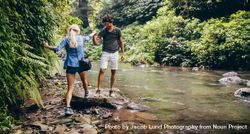 Young couple walking on the rocks by the river 0Jd1r4