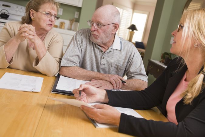 Adult Couple Going Over Papers in Their Home with Agent