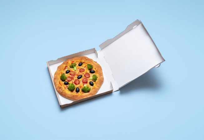 Vegan pizza in a cardboard box
