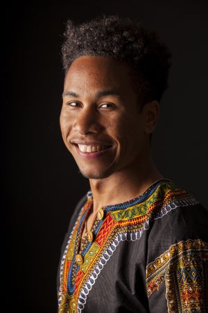 Black man smiling and looking at camera