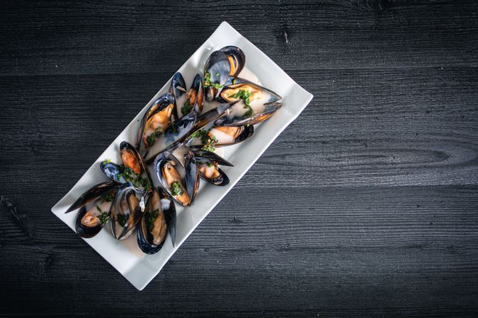 Steamed mussels with Thai sauce in plate