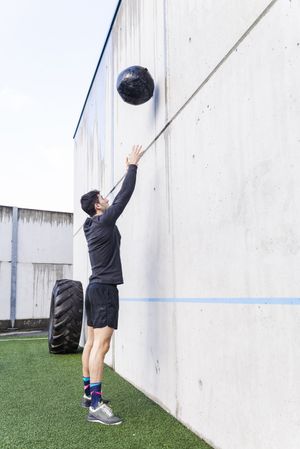 Man training with ball near wall