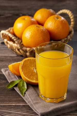 Glass with orange juice on the table.