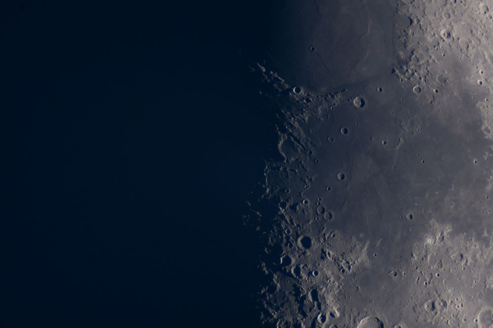 Close-up view of the moon's craters along lunar terminator.