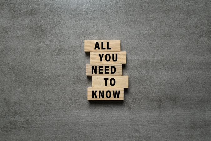 all you need to know words text symbol on wooden blocks isolated on cement background