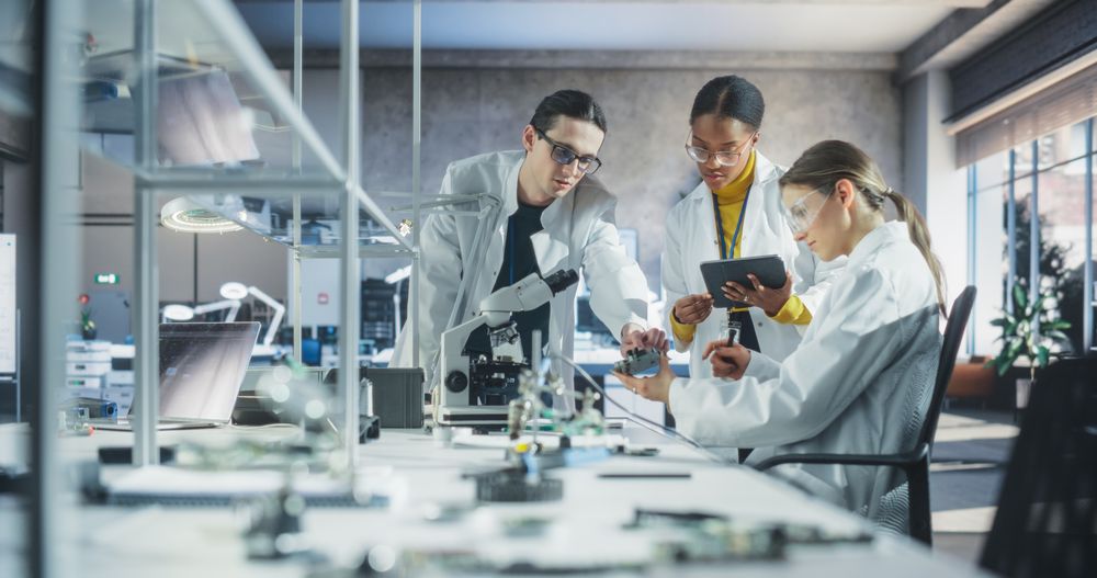 Young Team of Female and Male Students Working Together in Laboratory Classroom, Collaborating on a College Research Project.