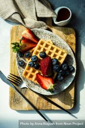 Looking down at waffle breakfast with blueberries & strawberries 4MGDZl