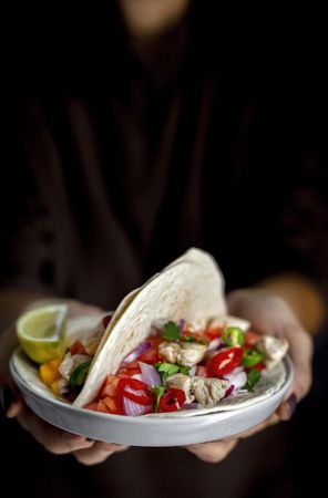 Woman's hands holding Mexican Tacos