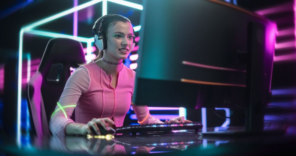 Gamer Sitting Behind an Interactive Digital Table, Streaming Gaming Content From a Futuristic Neon Room