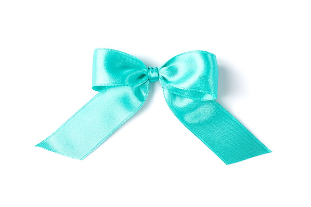 Turquoise bow isolated on plain background. Gift concept