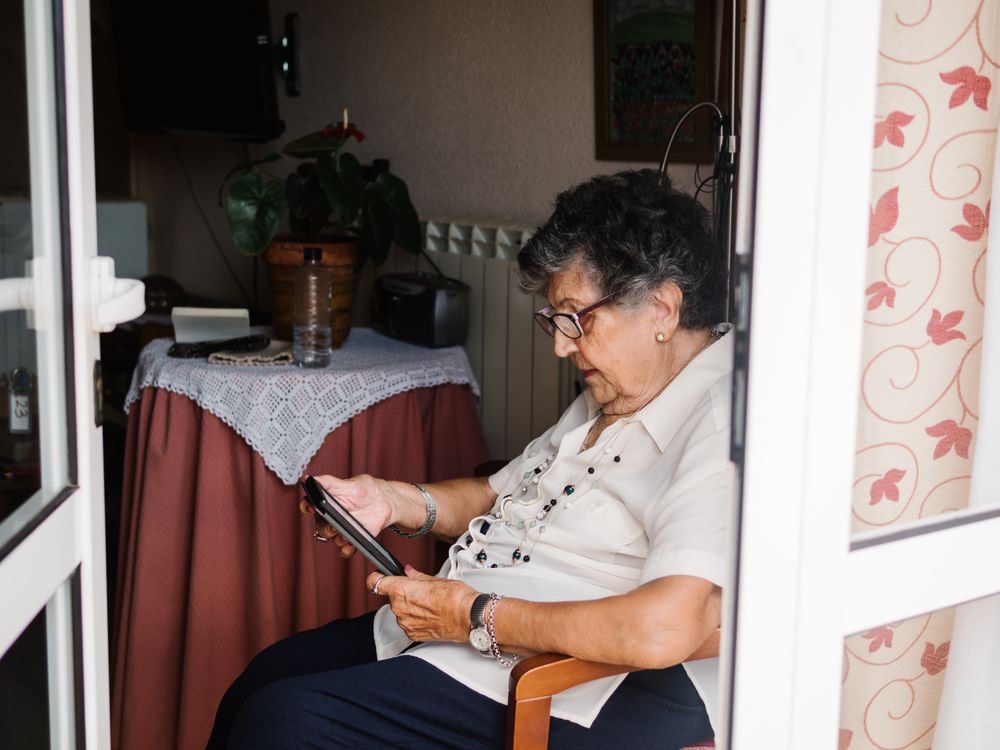 Mature female reading e-book at home