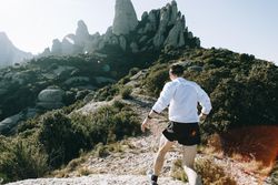 Man training on rocky trail in the hills