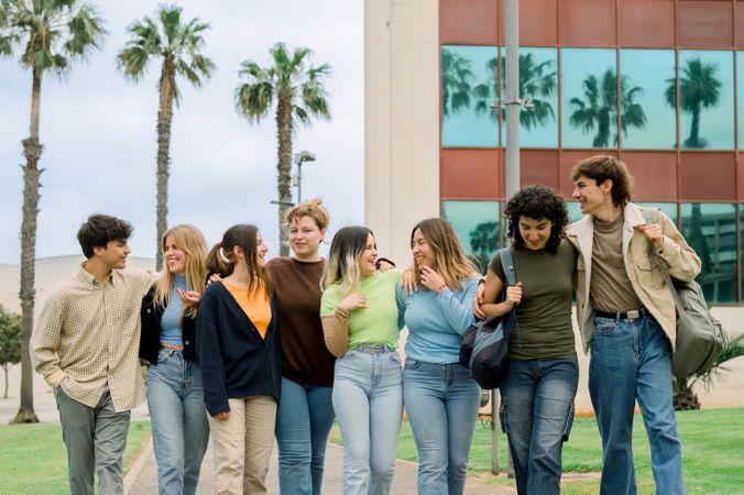 Group of happy multiracial students walking in campus