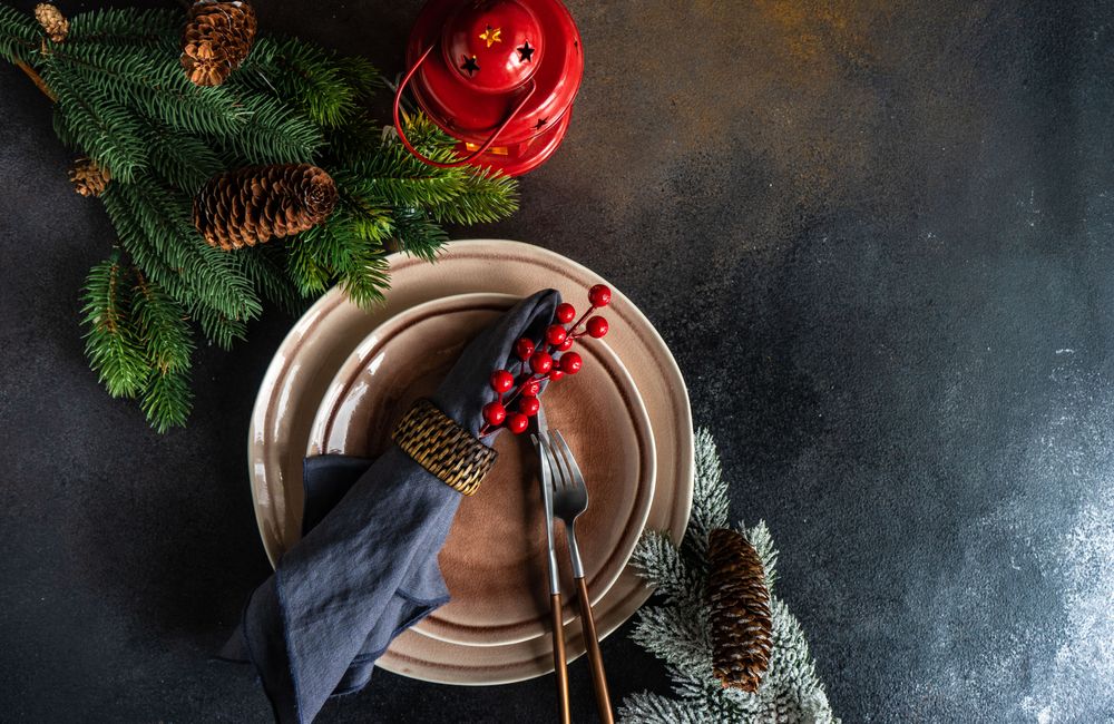 Top view of Christmas table setting with lantern and fern