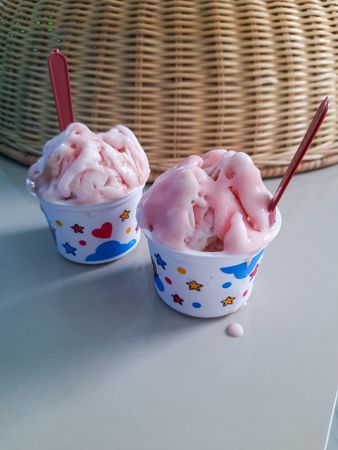 Two cups of ice cream, strawberry flavor