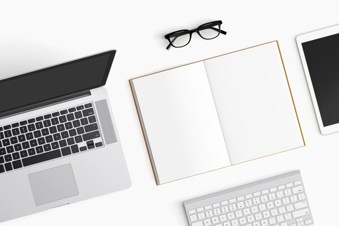 Modern workspace with coffee cup, notebook, tablet and laptop copy space