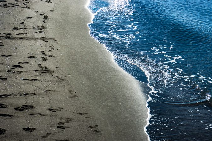 Dark volcanic beach and sea