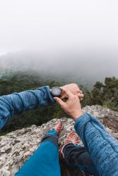 Man's hand with watch in the mountains