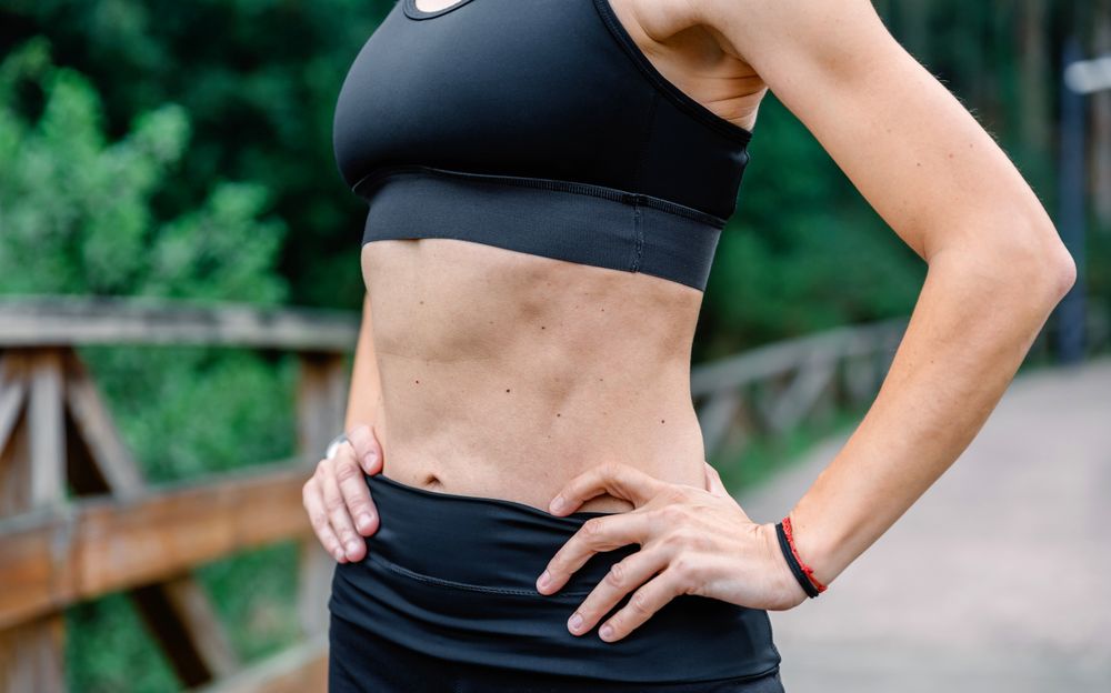 Athlete woman posing with sportswear