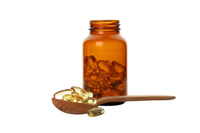 Brown bottle with omega pills, isolated on blank background