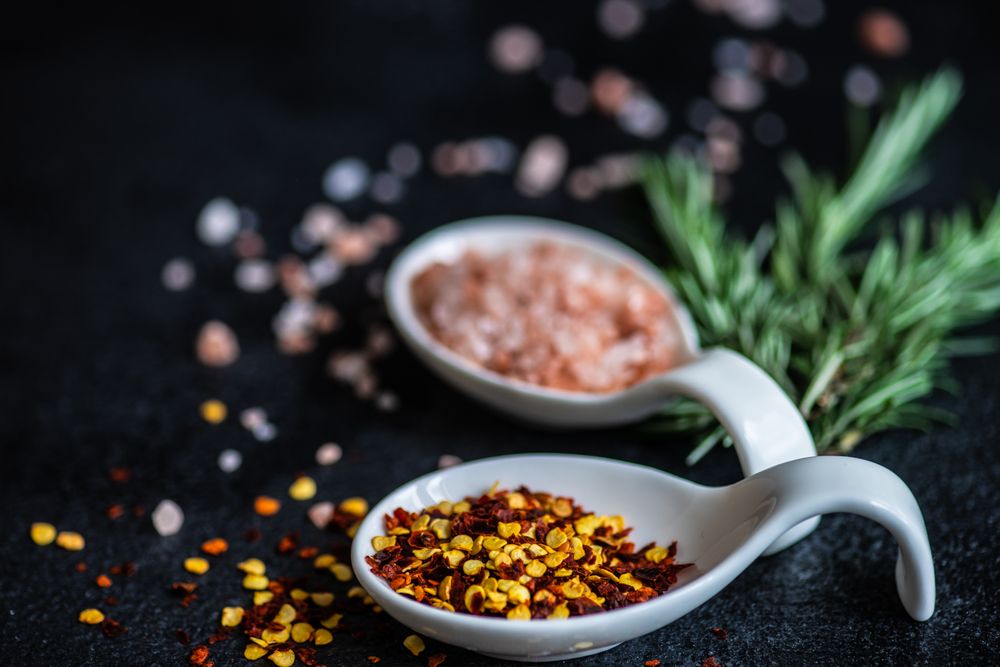 Close up of chilli flakes, rosemary and salt