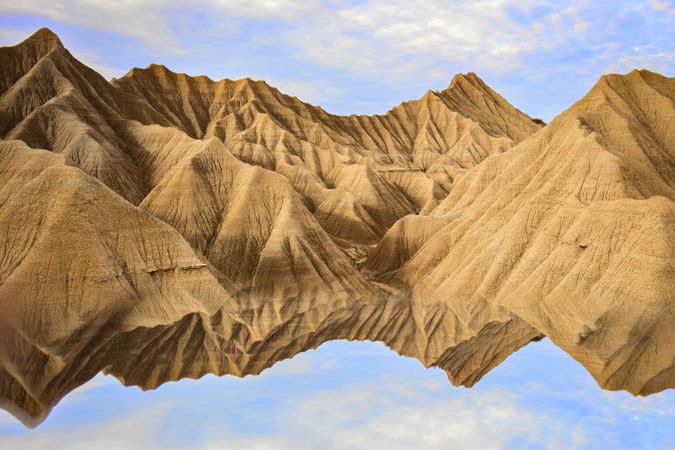 Water near stone desert hills and blue sky