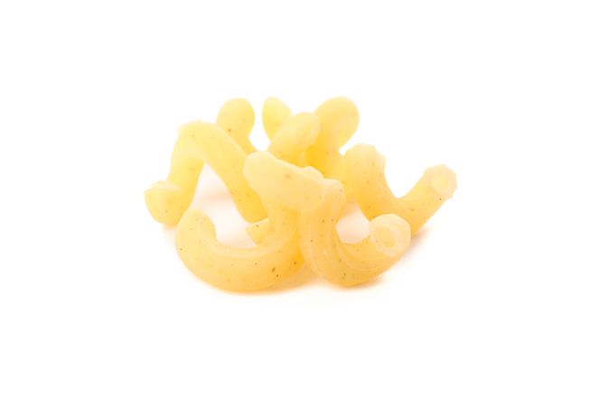 Pasta isolated on light background, closeup. Dry raw whole pasta
