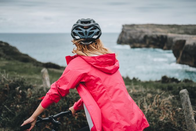 Female on bicycle enjoying landscape