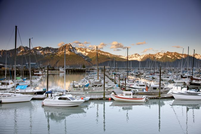 Boat marina with mountains in evening light in Alaska
