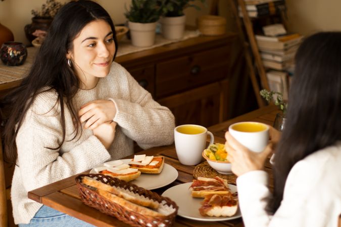 young woman having breakfast with her mother.