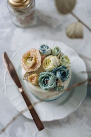 Buttercream flowers cake, blue and pastel peach colors