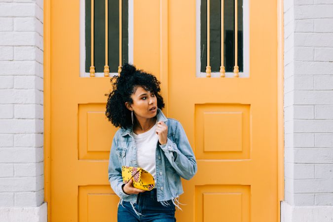 Stylish female by yellow door