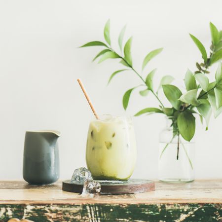 Iced matcha drink with creamer on side