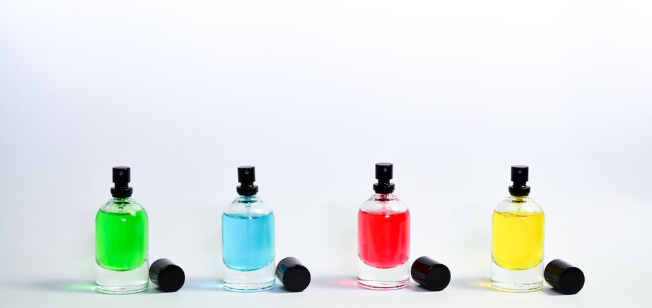 Four colorful perfume bottles in a row