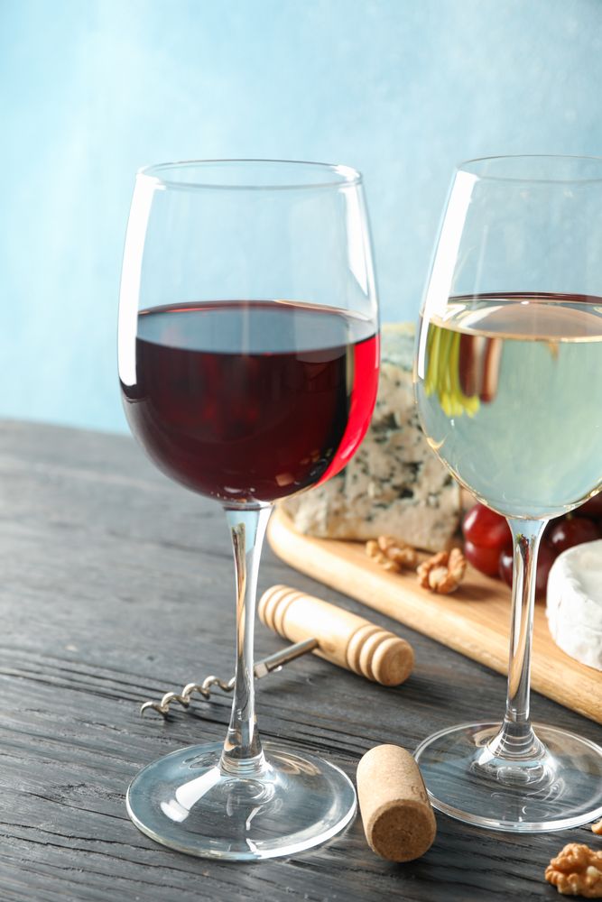 Grape, cheese, corkscrew, glasses with wine, on wooden background, copy space