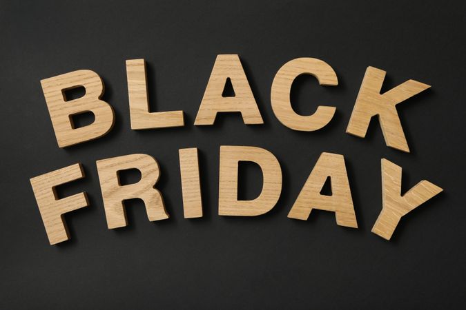 Text made of wooden letters on black background