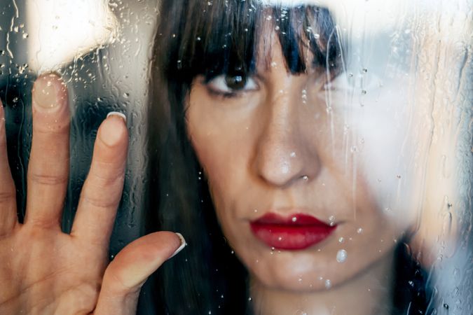 woman touching wet glass