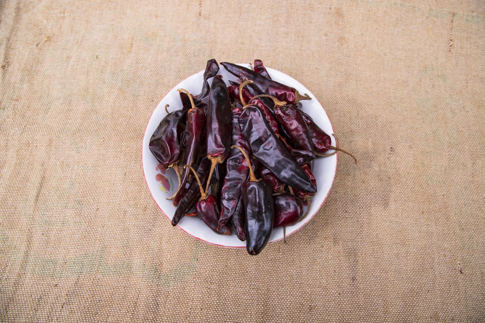 One bowl of Dry Pepper or red chili on the jute fiber fabric