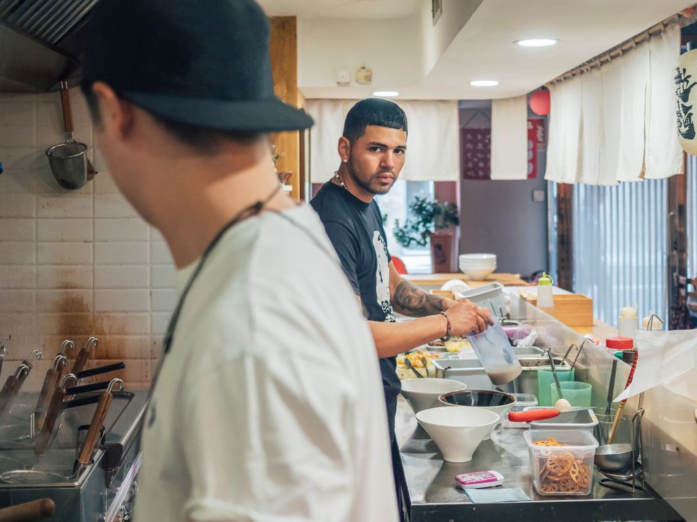 Multiethnic cooks working in kitchen of cafe