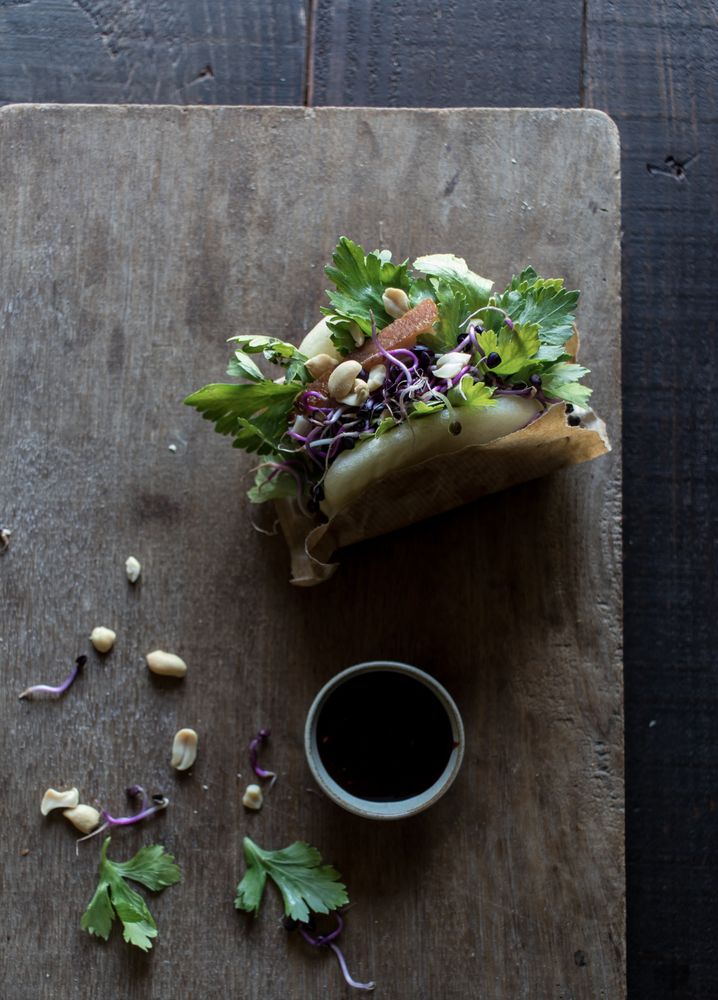Served Gua Bao sandwich with sauce on board