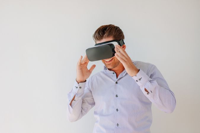 Shot of happy businessman watches content on a virtual reality display